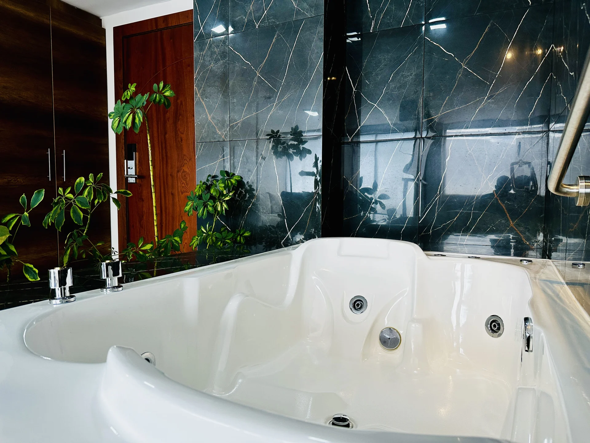 Baño con jacuzzi de mármol oscuro